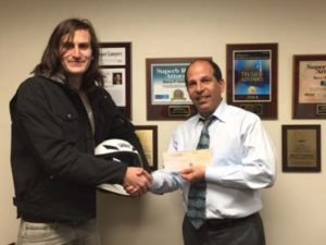 Barry giving 6 figure settlement check to motorcycle accident client