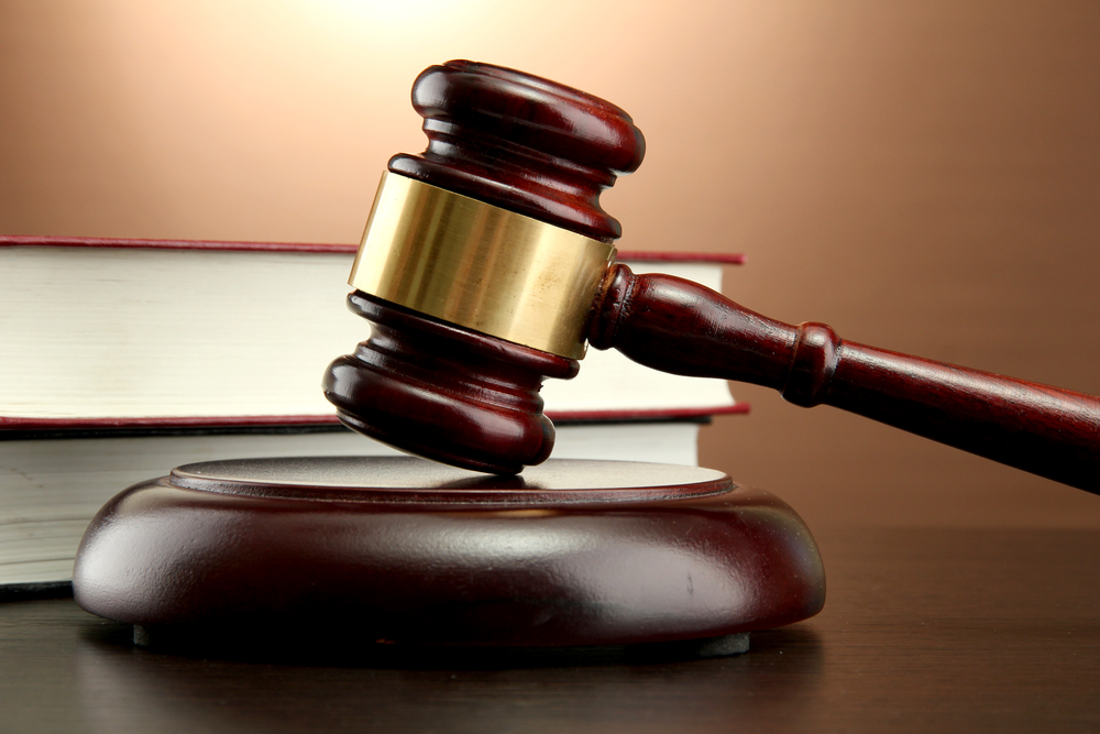 What Counts as Pain and Suffering in Court? - wooden gavel and books on wooden table, on brown background