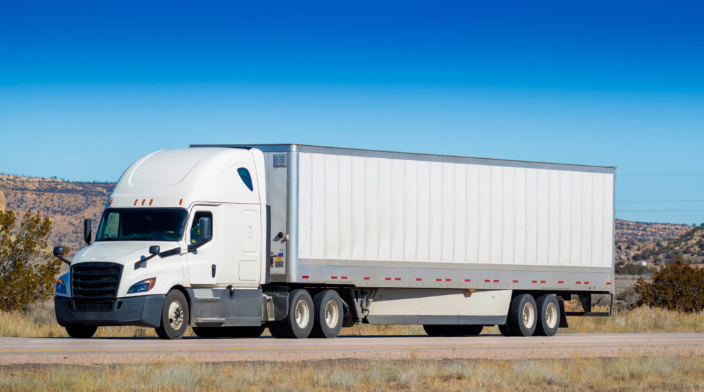 Truck Accident Lawyer Sylmar, CA - An Eighteen wheel big rig tractor trailer on highway. Trucking industry