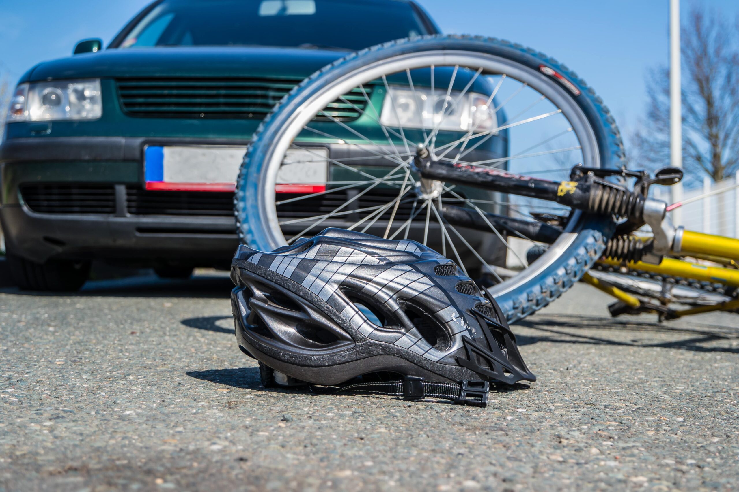 bike accident lawyer with bike and helmet on the road