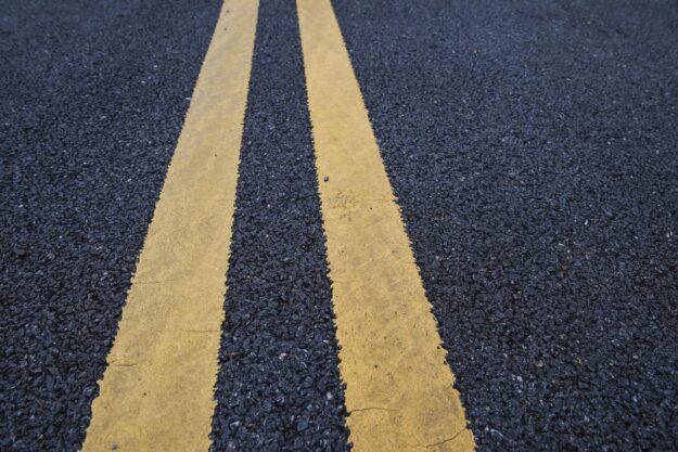 Rollover Car Accident Traps One Person - yellow double striped lines